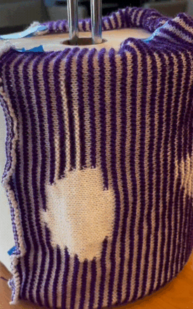 A gif showing the previous knit "animated". It is wrapped around a large cylinder and slowly spun from the leftmost to the rightmost frame.